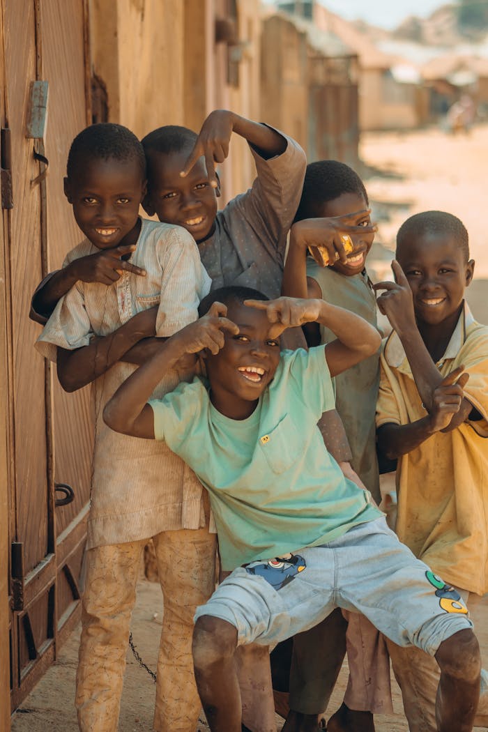 Group of happy children posing playfully in an outdoor street setting, capturing a moment of joy and friendship.